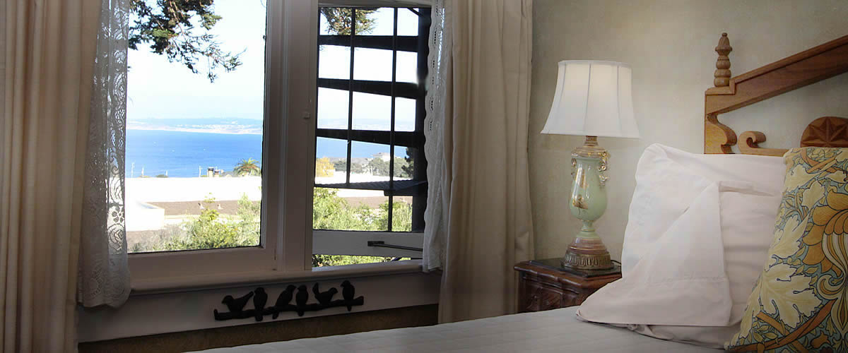 monterey bay bed and breakfast room with ocean views, bed and desk