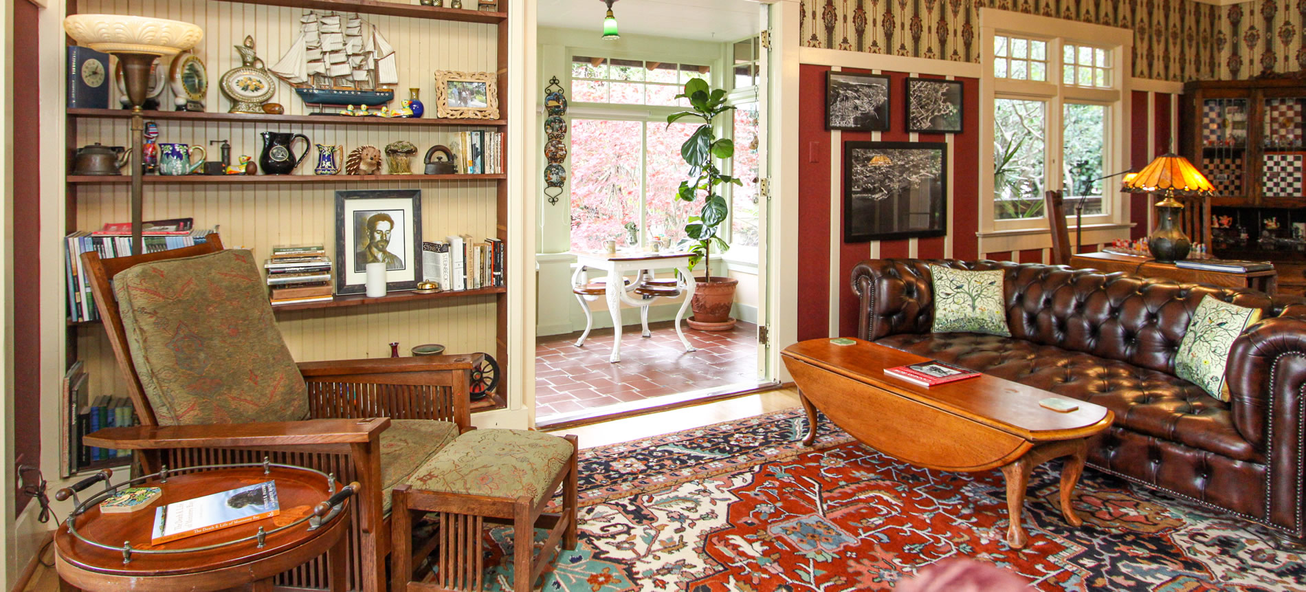 jabberwock inn living room with couch, chairs, tables and view of sun porch